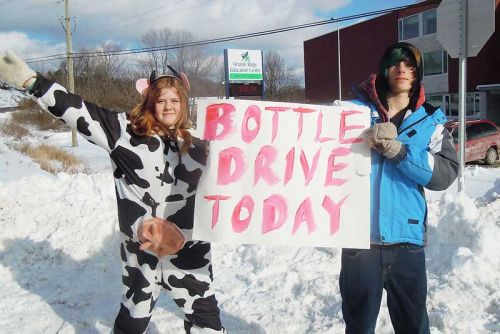 Grade 8 GREC students Katie Teal and Austin Hoselton attract local drivers to their bottle drive, a fundraiser for their end of the year grad trip to Montreal that took place on January 9 & 10.
